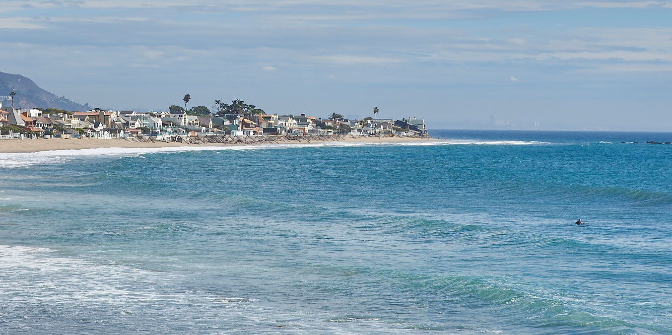 A lone surfer at Malibu Beach