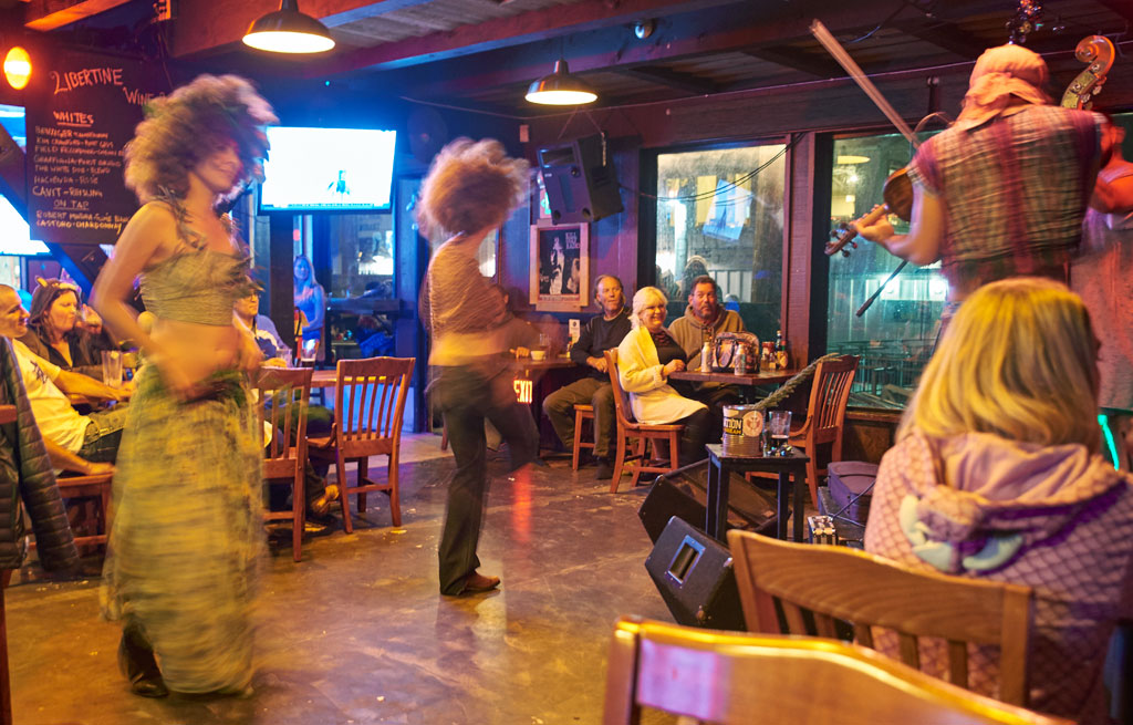 Costumed locals dance to a live Bluegrass music